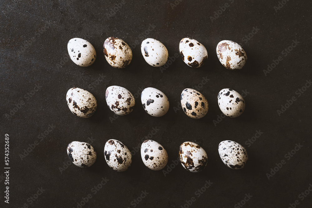 Quail eggs flat lay on rustic metal black background. Top view shot. Quail eggs flat lay on rustic metal black background. Top view shot.