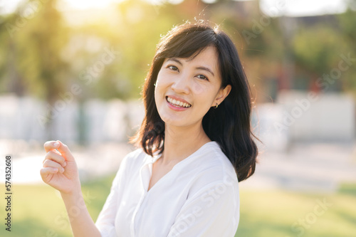 Portrait young beautiful asian woman with happy smile around outdoor park in sunny summer day