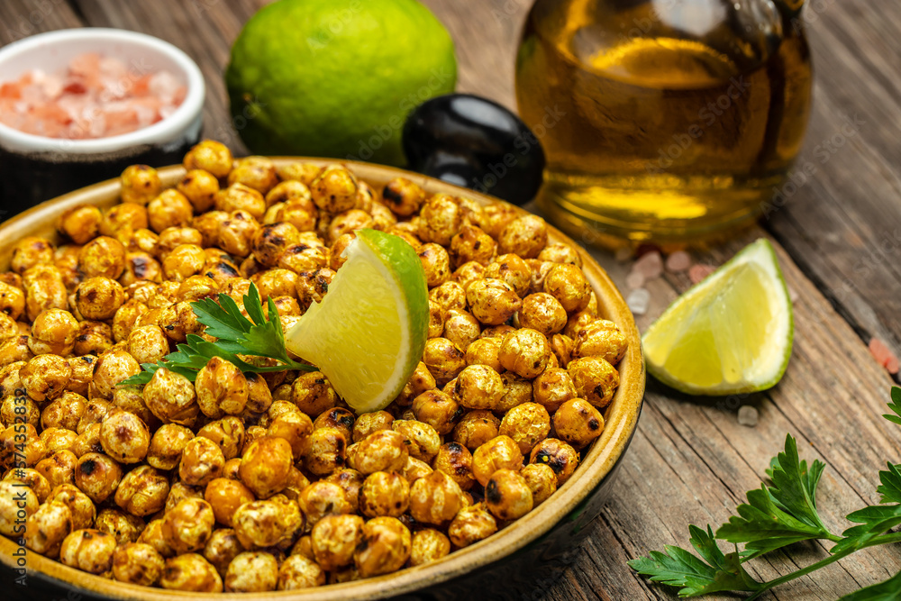Fried roasted spicy chickpeas or Indian chana or chole with lime. Tasty vegetarian and vegan chickpea snack. banner, menu, recipe place for text, top view
