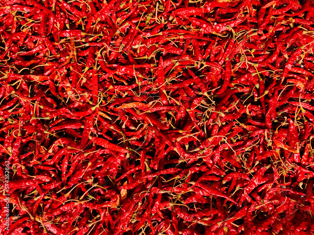 Naklejka premium Dried red peppers background. Red chili for cooking. Dry hot chilies background.