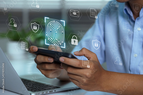 A user accesses document data via a laptop and smartphone equipped with a fingerprint scanner. Cyber security and data protection information privacy internet technology