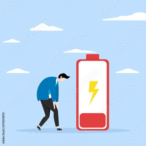 Low energy or motivation concept, stress or anxiety due to unhealthy work or depression and exhaustion, tired and exhausted from hard work, tired businessman looking down with low battery sign.