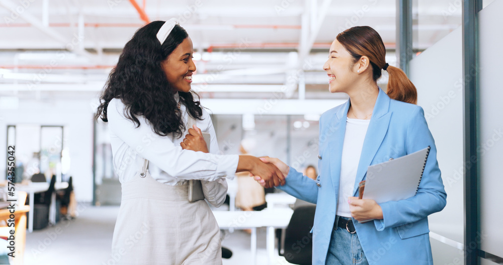 Business women, handshake and welcome, introduction and hello to new intern while walking in office. Happy, excited and diversity workers shaking hands for support, teamwork or onboarding partnership Business women, handshake and welcome, introduction and hello to new intern while walking in office. Happy, excited and diversity workers shaking hands for support, teamwork or onboarding partnership