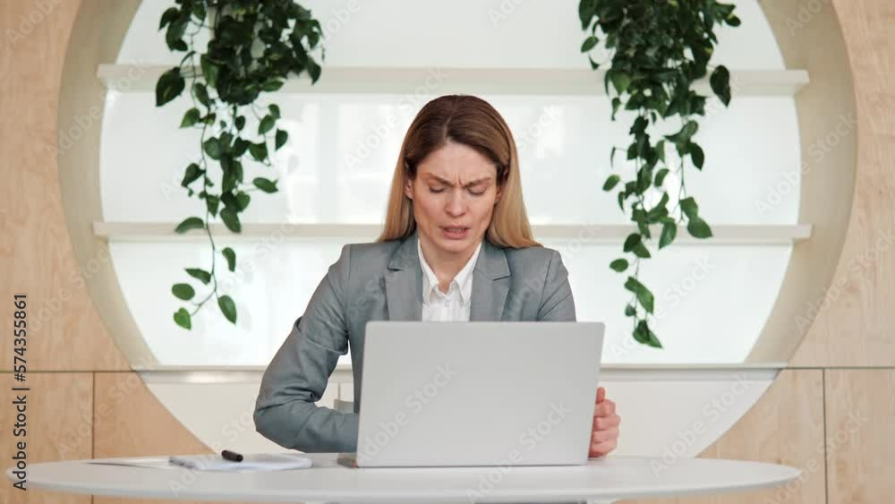 Ill unhealthy concentrated female employee suffer from severe pain in stomach. Young manager working on laptop standing in office workplace having belly ache, menstruation, discomfort diarrhea. Ill unhealthy concentrated female employee suffer from severe pain in stomach. Young manager working on laptop standing in office workplace having belly ache, menstruation, discomfort diarrhea.