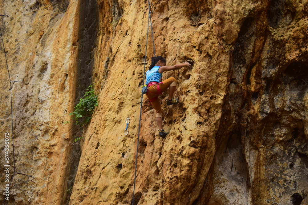 Rock climbing at Goa Pawon cliff in Bandung, West Java, Indonesia