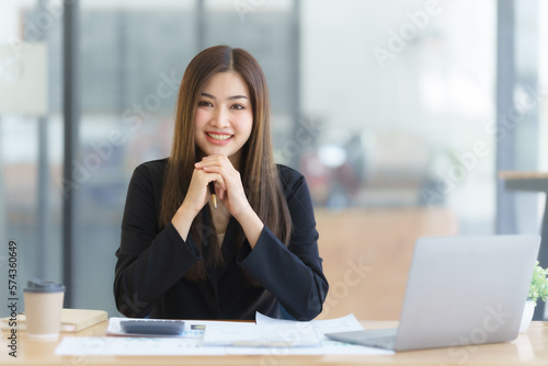 Attractive asia busy business woman consultant auditor working at modern office with balance sheet accounting bookkeeping documents. Account verification to prevent fraud bribery.