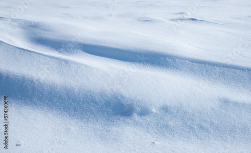 Snowdrifts after the heavy snowfall on the surface there are bumps and shadows