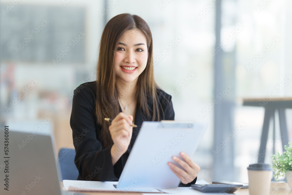 Attractive asia busy business woman consultant auditor working at modern office with balance sheet accounting bookkeeping documents. Account verification to prevent fraud bribery. Attractive asia busy business woman consultant auditor working at modern office with balance sheet accounting bookkeeping documents. Account verification to prevent fraud bribery.