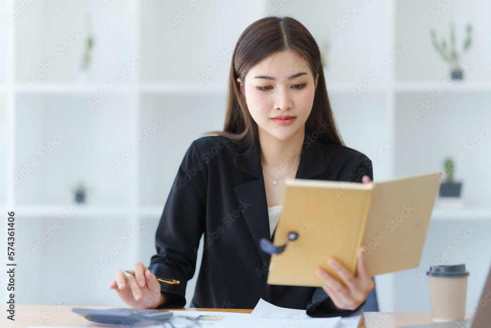 Attractive asia busy business woman consultant auditor working at modern office with balance sheet accounting bookkeeping documents. Account verification to prevent fraud bribery. Attractive asia busy business woman consultant auditor working at modern office with balance sheet accounting bookkeeping documents. Account verification to prevent fraud bribery.