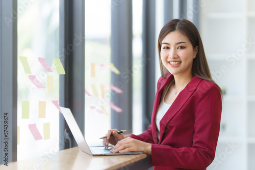 Attractive asia busy business woman consultant auditor working at modern office with balance sheet accounting bookkeeping documents. Account verification to prevent fraud bribery.