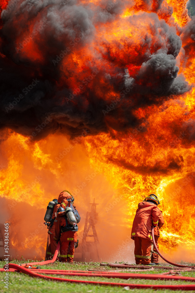firefighter training new fireman team stop Fire from oil plant blast explode. Fire fighter sprinkle water stop fire burn emergency case at gas station. rescue Care System of Insurance team. firefighter training new fireman team stop Fire from oil plant blast explode. Fire fighter sprinkle water stop fire burn emergency case at gas station. rescue Care System of Insurance team.