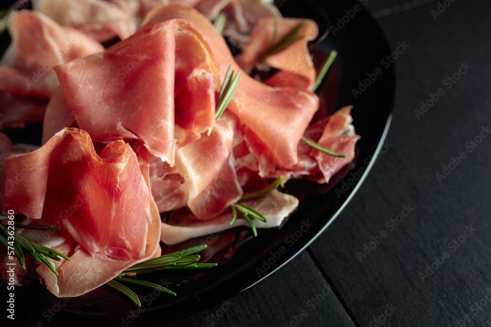 Italian prosciutto or Spanish jamon with rosemary. Italian prosciutto or Spanish jamon with rosemary.