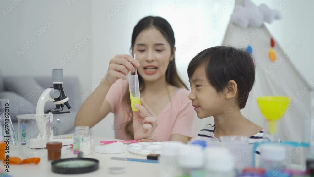 An Asian student kids and mother study, learn on test tube in lab or laboratory in school, medical, chemistry. Experiment science. Education in classroom. People lifestyle An Asian student kids and mother study, learn on test tube in lab or laboratory in school, medical, chemistry. Experiment science. Education in classroom. People lifestyle