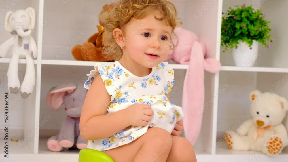 The child sits on the potty. Selective focus. The child sits on the potty. Selective focus.