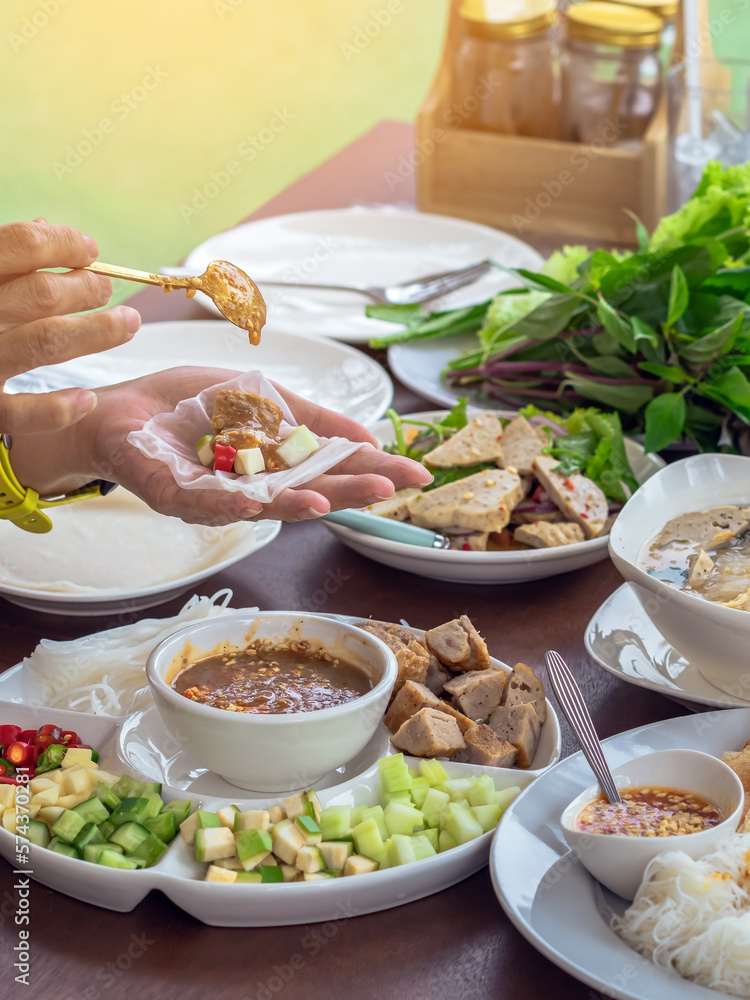 Enjoy eat with Vietnamese Meatball Wraps (Nam-Neung), Pork Sausage wraps with fresh vegetables in rice paper, generous platter eat with sweet sauce. Vietnamese Pork Sausage and salad. Selective focus. Enjoy eat with Vietnamese Meatball Wraps (Nam-Neung), Pork Sausage wraps with fresh vegetables in rice paper, generous platter eat with sweet sauce. Vietnamese Pork Sausage and salad. Selective focus.