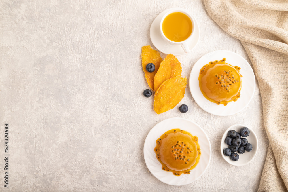 Mango and passion fruit jelly with blueberry on gray concrete, top view, copy space. Mango and passion fruit jelly with blueberry on gray concrete, top view, copy space.
