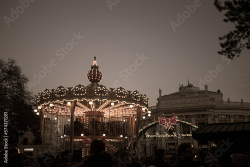 View of a merry-go-round at the Christmas market on the town hall square in Vienna, Austria.