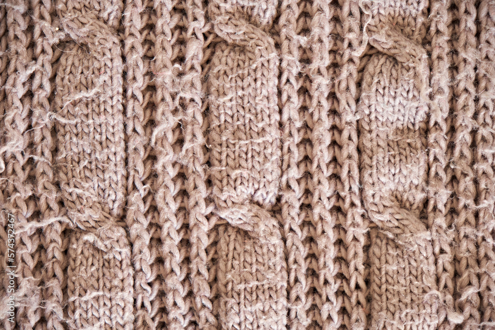 Light brown melange yarn fabric knitted texture. Marl wool knitting background. Up close