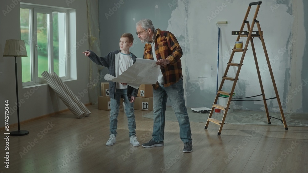 Grandpa and grandson are looking through sheet with plan of an apartment and discussing renovation project. Elderly man and young boy are planning the improvement of their home. Concept of repair