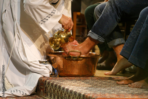 Maundy Thursday celebration in a Parisian catholic church. Priest washing faithfuls' feet.