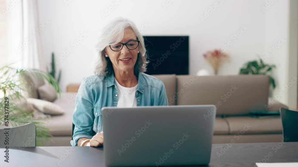 Video of cute granddaughter with grandmother waving hand during video call using laptop at home. Video of cute granddaughter with grandmother waving hand during video call using laptop at home.