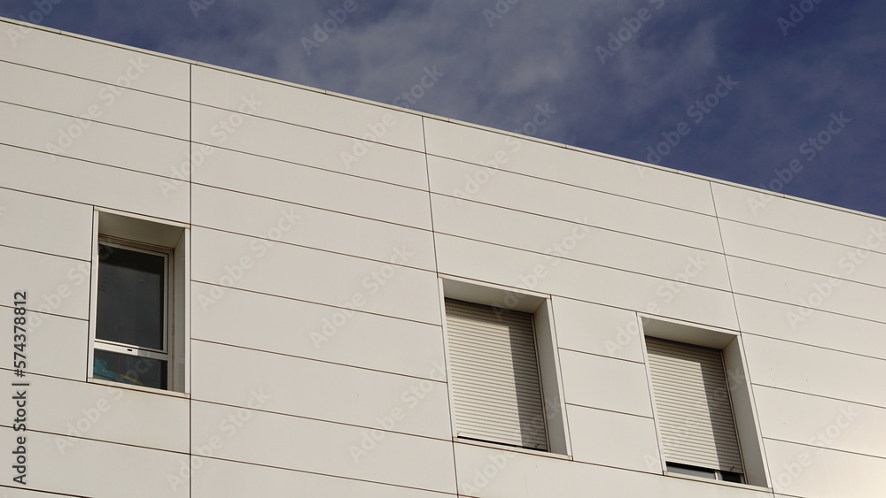 white facade with windows against the sky