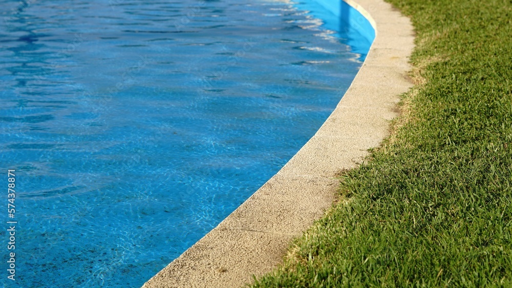 edge of a pool with grass floor