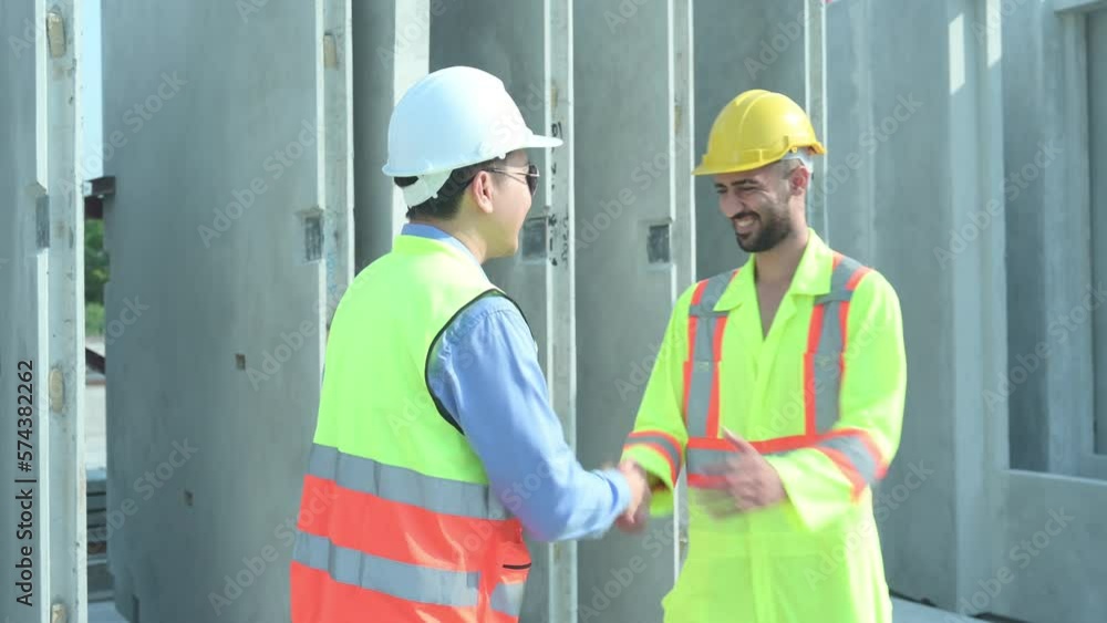 Both of construction engineers verify the constructed precast concrete wall slabs' quality. also to oversee significant construction projects in the construction zone Both of construction engineers verify the constructed precast concrete wall slabs' quality. also to oversee significant construction projects in the construction zone