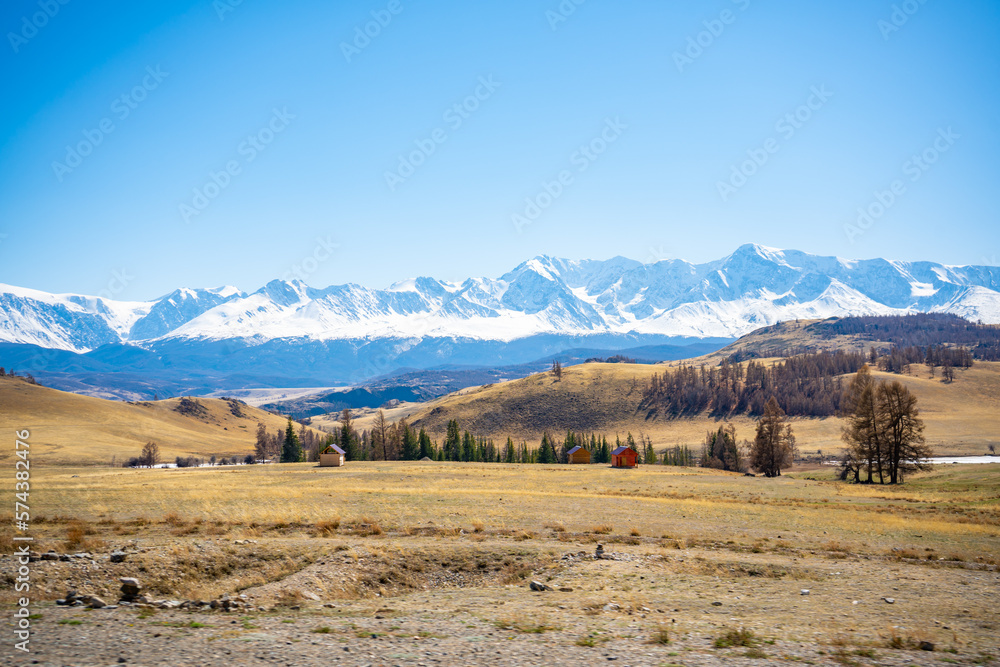 Fototapeta premium Scenic view with the beautiful mountain peaks with snow and glaciers, blue sky and the valley in the sunlight in Altai, Russia