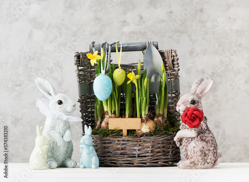 Happy easter festive card with Easter eggs, Bunnies and beautiful spring flowers in the basket. easter concept