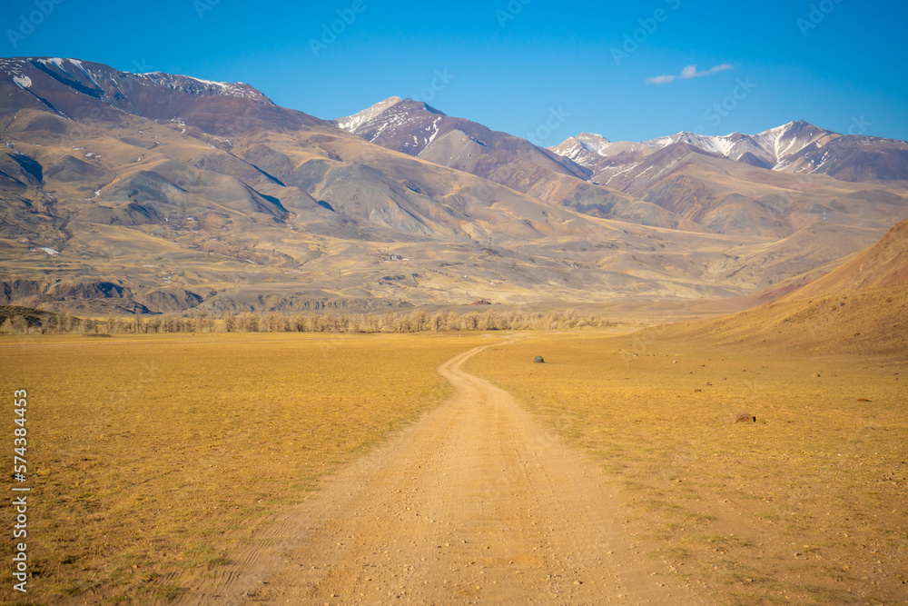 Road in Kyzyl-Chin valley or Mars valley with mountain background in Altai, Siberia, Russia. Road in Kyzyl-Chin valley or Mars valley with mountain background in Altai, Siberia, Russia.