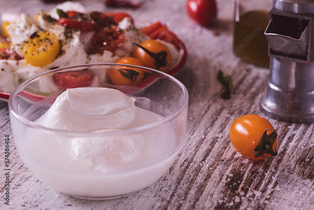 Mozzarella cheese and tomatoes in the background Mozzarella cheese and tomatoes in the background