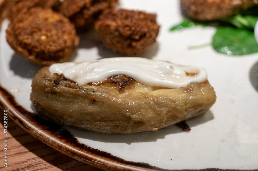 Healthy vegetarian food, vegan falafel balls served with grilles baked eggplant and grilled avocado Healthy vegetarian food, vegan falafel balls served with grilles baked eggplant and grilled avocado
