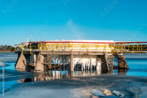 Ice covered metal construction of spillway on a small dam