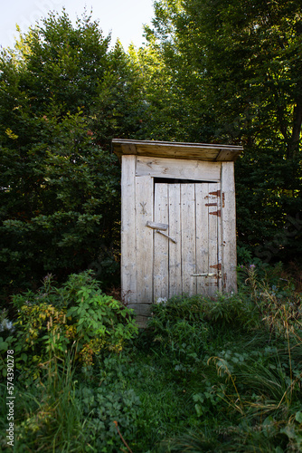 Wooden toilet in a forest grove. Toilet outside in rustic style.