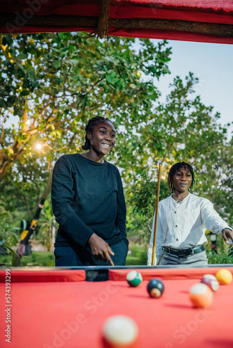 Queer masculine women playing pool