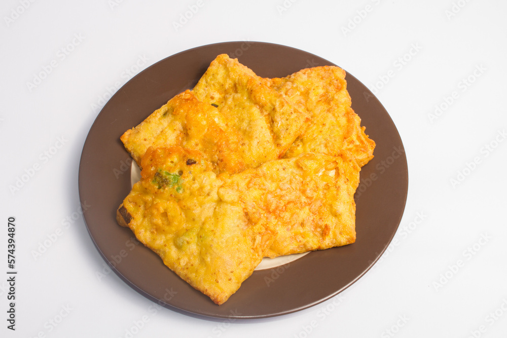 Fried Tempe is Indonesian famous food served on a plate with white background Fried Tempe is Indonesian famous food served on a plate with white background
