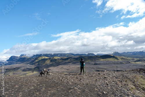 Hiker standing and admiring nature in Iceland. Backpacker enjoying the view of Icelandic landscape © Renata