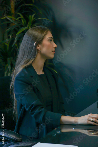 portrait of a woman working on computer screen during marketing meeting professional work day female smile pretty office long hair 
