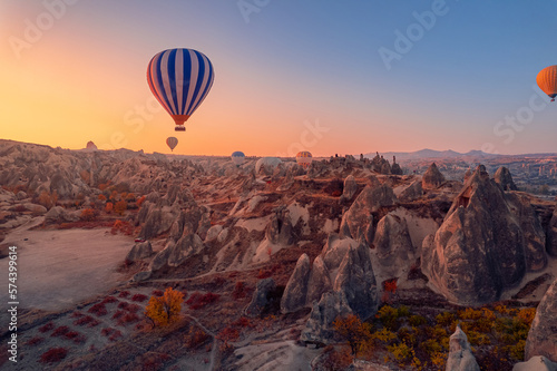 Amazing sunrise Cappadocia with set colorful hot air balloons fly in pink sky with first sun light. Turkey travel Concept, aerial view © Parilov