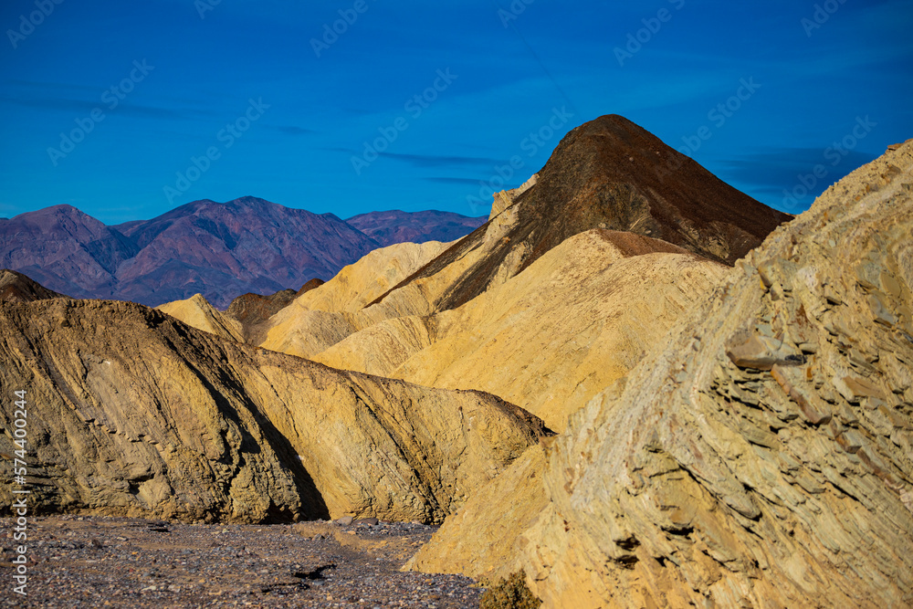 panorama of the mountains in golden canyon during the spring sunrise; the famous coloured mountains which can be seen from zabriskie point; hiking in golden canyon in death valley national park