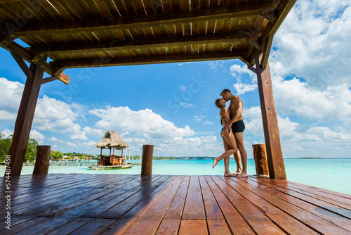 Couple relaxing on a pier Bacalar lagoon Mexico photo