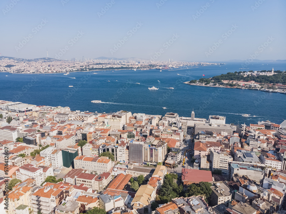 Top view of the old city of Istanbul and the Bosphorus, in the foreground low-rise buildings, against the backdrop of city hills, on a warm summer day