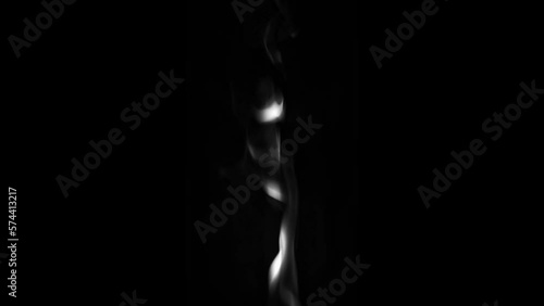 Smoke rises in a trickle from bottom to top on a dark background. High quality Full HD footage.