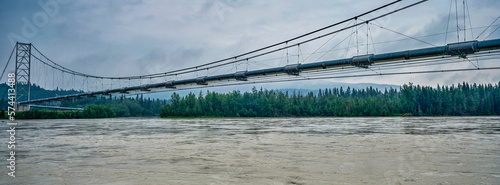 Panoramic image of The Alaska oil pipeline suspended over the Tananna River in Alaska