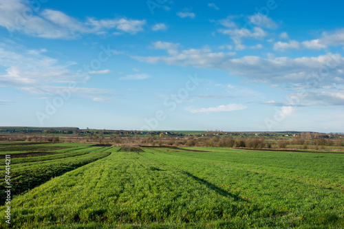 Plowed field under the background of blue sky © mikhailgrytsiv