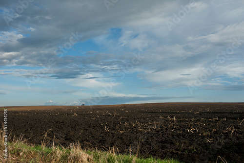Plowed field under the background of blue sky