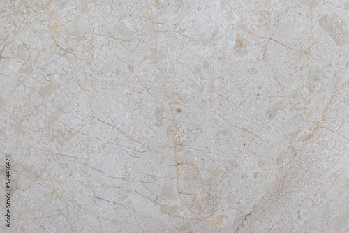 White marble tiles with beige patterns and real scratches. White textured background made of marble.