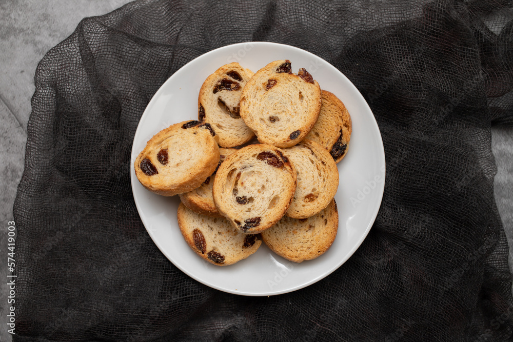 Mini round toasts of bread with raisins on dish Mini round toasts of bread with raisins on dish