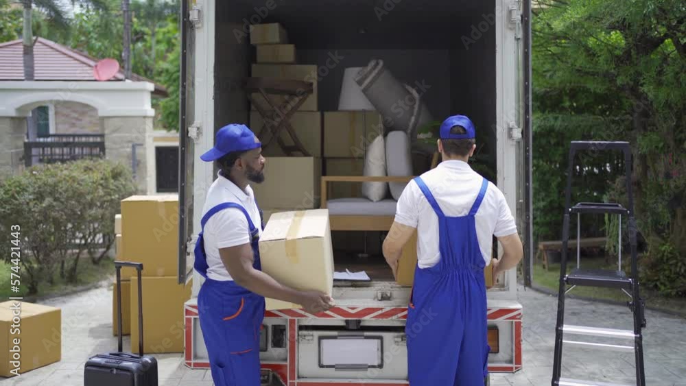 Team of employee workers with a truck car moving house for customers, delivering boxes with uniform.Vehicle transportation. Shipping and packaging business occupation service company. People lifestyle Team of employee workers with a truck car moving house for customers, delivering boxes with uniform.Vehicle transportation. Shipping and packaging business occupation service company. People lifestyle